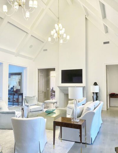 A white living room with a vaulted ceiling.